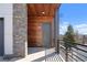 Stylish front entrance featuring a modern gray door, wood accents, and stone detailing at 145 Hutchinson Ne St, Atlanta, GA 30307