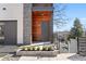 Elegant front entrance featuring a sleek gray door, stone and wood accents, and landscaped details at 145 Hutchinson Ne St, Atlanta, GA 30307