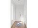 Inviting hallway with hardwood floors, white door, minimalist decor, and ample sunlight at 145 Hutchinson Se St, Atlanta, GA 30307