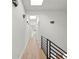 Hallway features hardwood floors, modern lighting, and a staircase with black railings at 145 Hutchinson Ne St, Atlanta, GA 30307