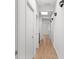 Bright hallway with hardwood floors, recessed lighting, and modern wall sconces at 145 Hutchinson Ne St, Atlanta, GA 30307