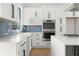Well-lit kitchen featuring white countertops, modern appliances, and a blue subway tile backsplash at 145 Hutchinson Ne St, Atlanta, GA 30307