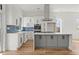 Bright kitchen featuring a center island, modern appliances, and sleek white and gray cabinetry at 145 Hutchinson Ne St, Atlanta, GA 30307