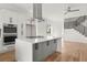 Open-concept kitchen featuring a center island and modern appliances, flowing into the staircase at 145 Hutchinson Ne St, Atlanta, GA 30307