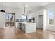 Modern kitchen with white cabinets, gray island, stainless steel appliances, and hardwood floors at 145 Hutchinson Ne St, Atlanta, GA 30307