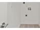 Spacious laundry room featuring clean white walls, modern flooring, and essential utility connections at 145 Hutchinson Ne St, Atlanta, GA 30307