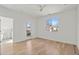 Bright main bedroom featuring hardwood floors, ensuite bathroom, and a ceiling fan at 145 Hutchinson Ne St, Atlanta, GA 30307