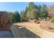 Landscaped backyard featuring brick retaining walls and a newly seeded lawn at 155 Saddleview Run, Atlanta, GA 30350