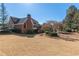 Expansive backyard of brick home with mature trees, landscaping, and plenty of open space at 155 Saddleview Run, Atlanta, GA 30350