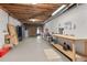 Unfinished basement area for storage or workshop with pegboard walls and overhead lighting at 155 Saddleview Run, Atlanta, GA 30350