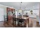 Traditional dining room with wood floors, wooden table with chairs, and a built-in hutch at 155 Saddleview Run, Atlanta, GA 30350