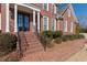 Inviting front porch with brick steps, white columns, and black railing, leading to the home's entrance at 155 Saddleview Run, Atlanta, GA 30350