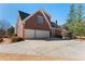 Exterior features a brick home, 2 car garage, and extended driveway at 155 Saddleview Run, Atlanta, GA 30350