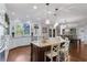 Bright, open eat-in kitchen with white cabinets, granite counters, and large windows with wooded views at 155 Saddleview Run, Atlanta, GA 30350