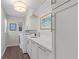Bright laundry room with custom cabinets, stylish lighting, and modern appliances at 155 Saddleview Run, Atlanta, GA 30350