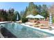 Sparkling in-ground pool with sun loungers and umbrellas, perfect for relaxation and entertainment at 155 Saddleview Run, Atlanta, GA 30350