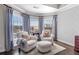 Cozy sitting area with windows and two chairs with an ottoman, and wood floors at 155 Saddleview Run, Atlanta, GA 30350