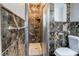 Bathroom with walk in shower with dark stone tiling on the walls at 1753 Dodson Sw Dr, Atlanta, GA 30311