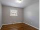 Bedroom features hardwood floors, a window, and neutral walls at 1753 Dodson Sw Dr, Atlanta, GA 30311