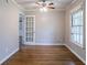 Cozy room with hardwood floors, white trim, a ceiling fan, and ample natural light at 1753 Dodson Sw Dr, Atlanta, GA 30311