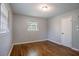 Bedroom with hardwood floors, gray walls, white door and window at 1753 Dodson Sw Dr, Atlanta, GA 30311