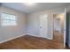Bedroom with hardwood floors, gray walls, view to hallway at 1753 Dodson Sw Dr, Atlanta, GA 30311