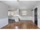 Dining area features hardwood floors, window, and view of the kitchen at 1753 Dodson Sw Dr, Atlanta, GA 30311