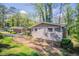 Side view of a well-maintained home with brick and siding, complemented by mature landscaping at 1753 Dodson Sw Dr, Atlanta, GA 30311