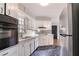 Kitchen features stainless appliances, white cabinets, black flooring at 1753 Dodson Sw Dr, Atlanta, GA 30311