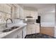 Kitchen features stainless sink, white cabinets, and view of the dining area at 1753 Dodson Sw Dr, Atlanta, GA 30311