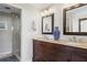 Bathroom with dual sinks, granite countertop, decorative vase, and walk-in shower at 180 Stone Mill Trl, Atlanta, GA 30328