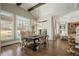 Dining room with vaulted ceilings, large windows and a modern chandelier at 6265 Polo Dr, Cumming, GA 30040