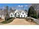 Elegant two-story home with white brick facade and beautifully landscaped front yard at 6265 Polo Dr, Cumming, GA 30040