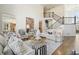 Inviting living room with a view of the staircase, featuring comfortable seating, chess set, and hardwood floors at 6265 Polo Dr, Cumming, GA 30040