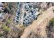 Real estate aerial view showing a suburban neighborhood in wooded terrain at 3928 Ashford Lake Ne Ct, Brookhaven, GA 30319