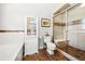 Clean bathroom with glass-door shower, decorative tile accents, and a storage cabinet at 3928 Ashford Lake Ne Ct, Brookhaven, GA 30319