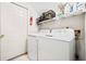 Clean and efficient laundry room with white appliances, storage shelves, and ample workspace at 3928 Ashford Lake Ne Ct, Brookhaven, GA 30319