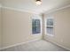 Bedroom with neutral walls, plush carpet, a window, and crisp white trim at 5232 Centennial Hill Nw Dr, Acworth, GA 30102