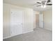 This bedroom features plush gray carpet, a ceiling fan, and a closet at 5232 Centennial Hill Nw Dr, Acworth, GA 30102