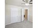 This bedroom features plush gray carpet, a ceiling fan, and a closet at 5232 Centennial Hill Nw Dr, Acworth, GA 30102