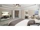 Staged bedroom showcasing neutral tones, a sitting area, and a doorway leading to the bathroom at 5232 Centennial Hill Nw Dr, Acworth, GA 30102