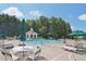 A community pool with lounge chairs and green sun umbrellas at 5232 Centennial Hill Nw Dr, Acworth, GA 30102