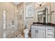 Bright bathroom featuring a glass-enclosed shower and a granite-topped vanity with modern fixtures and hardware at 1244 Janmar Rd, Snellville, GA 30078