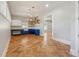 A bright kitchenette features herringbone floors, blue cabinets, and open shelving at 1244 Janmar Rd, Snellville, GA 30078