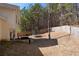 Large fenced backyard featuring a trampoline, patio, and a wooded backdrop at 2860 River Close Dr, Decatur, GA 30034