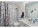 Bathroom showcasing a tub with shower with a sleek vanity and modern fixtures at 2860 River Close Dr, Decatur, GA 30034