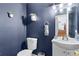 Cozy half bath featuring blue walls and a decorative mirror, providing a touch of charm at 2860 River Close Dr, Decatur, GA 30034