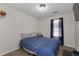 Neutral bedroom featuring a window, a bed with blue comforter and carpeted floors at 2860 River Close Dr, Decatur, GA 30034