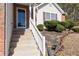 A home entrance with concrete steps and a white railing with landscaping around at 2860 River Close Dr, Decatur, GA 30034
