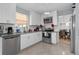 Well-lit kitchen featuring white cabinets, stainless steel appliances, and tile flooring at 2860 River Close Dr, Decatur, GA 30034